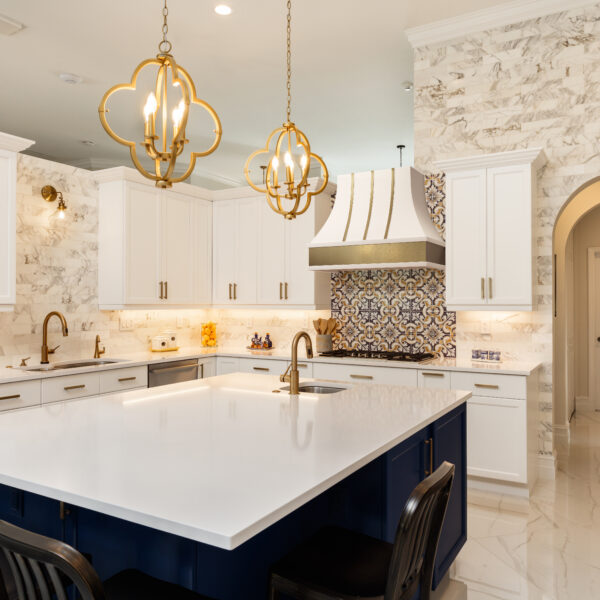 Curved custom wood range hood with gold strap accents