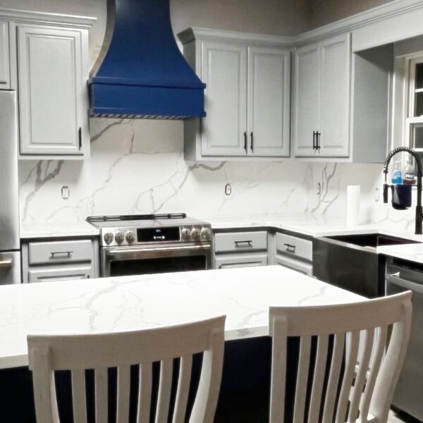 Custom wood range hood installed in modern kitchen