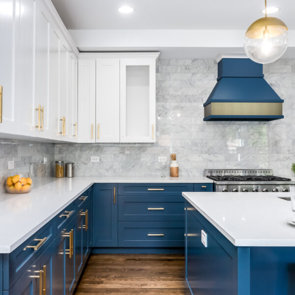 Custom wood range hood with gold hardware accents
